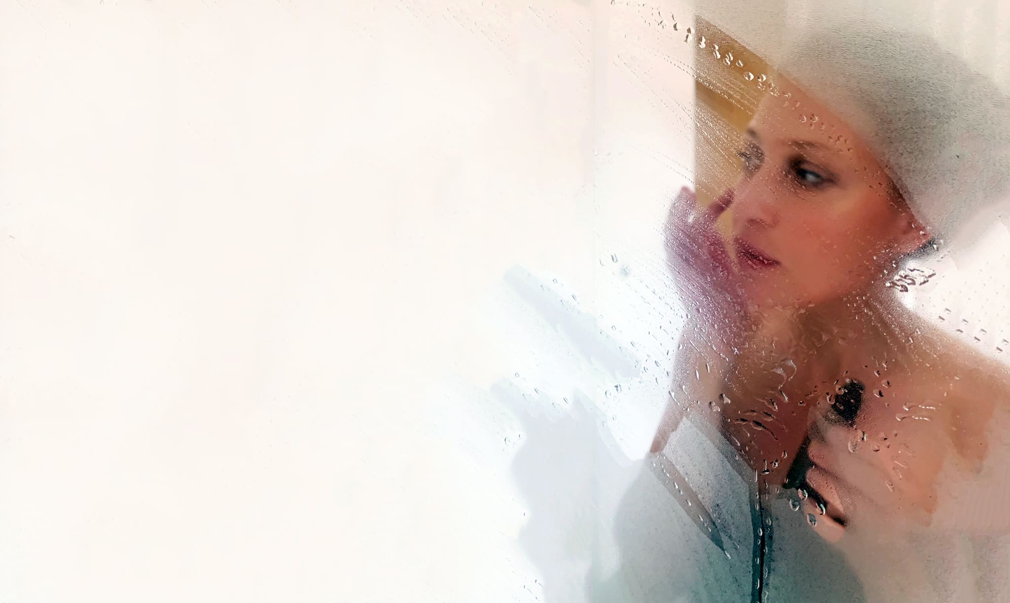 Hand applying eyeliner at a steamy bathroom mirror, evoking polyamory vocabulary and the language of non-monogamy, by Victoria Onken.